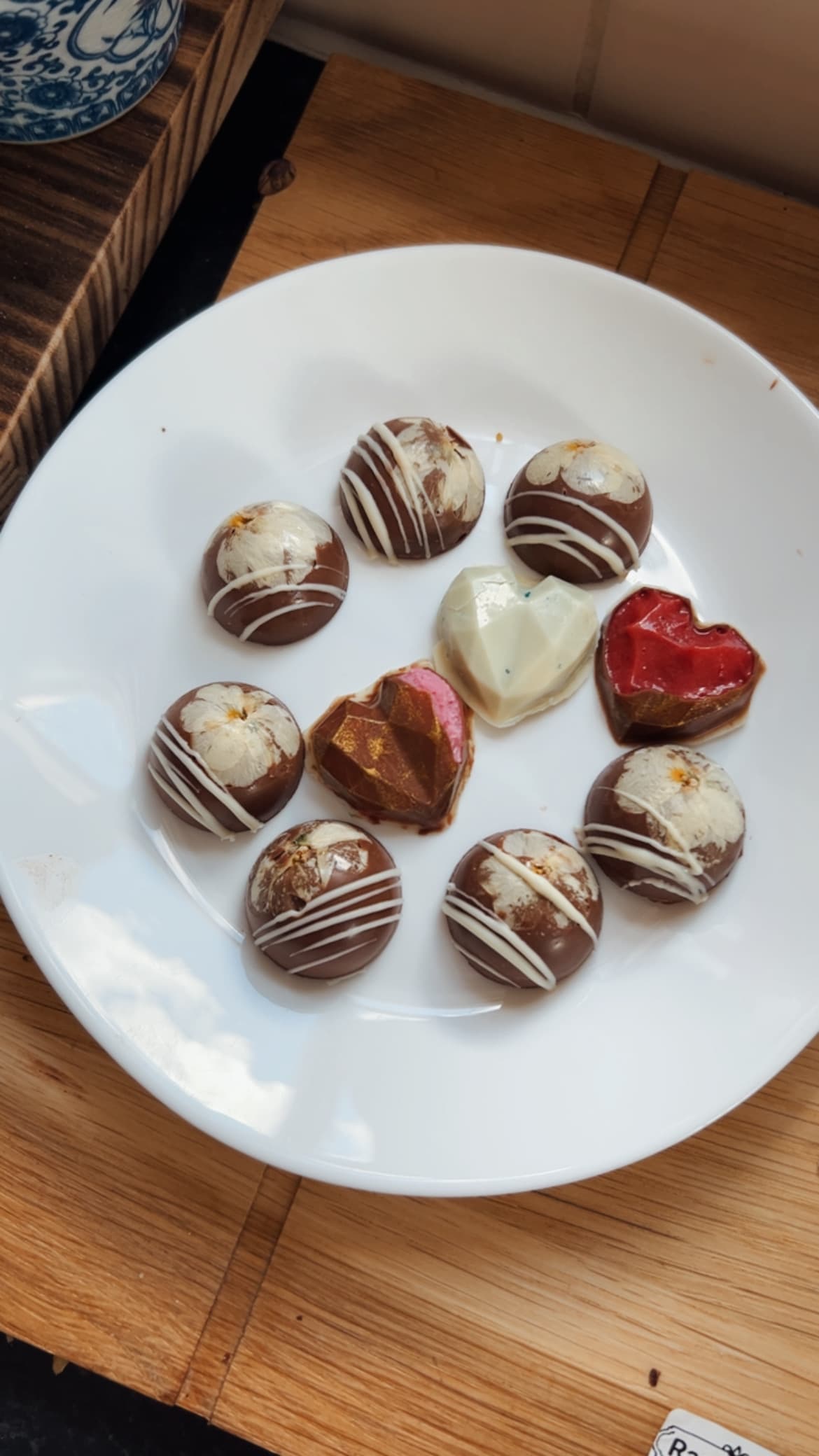 Sculpted chocolate hearts and flower-pressed truffles on a plate