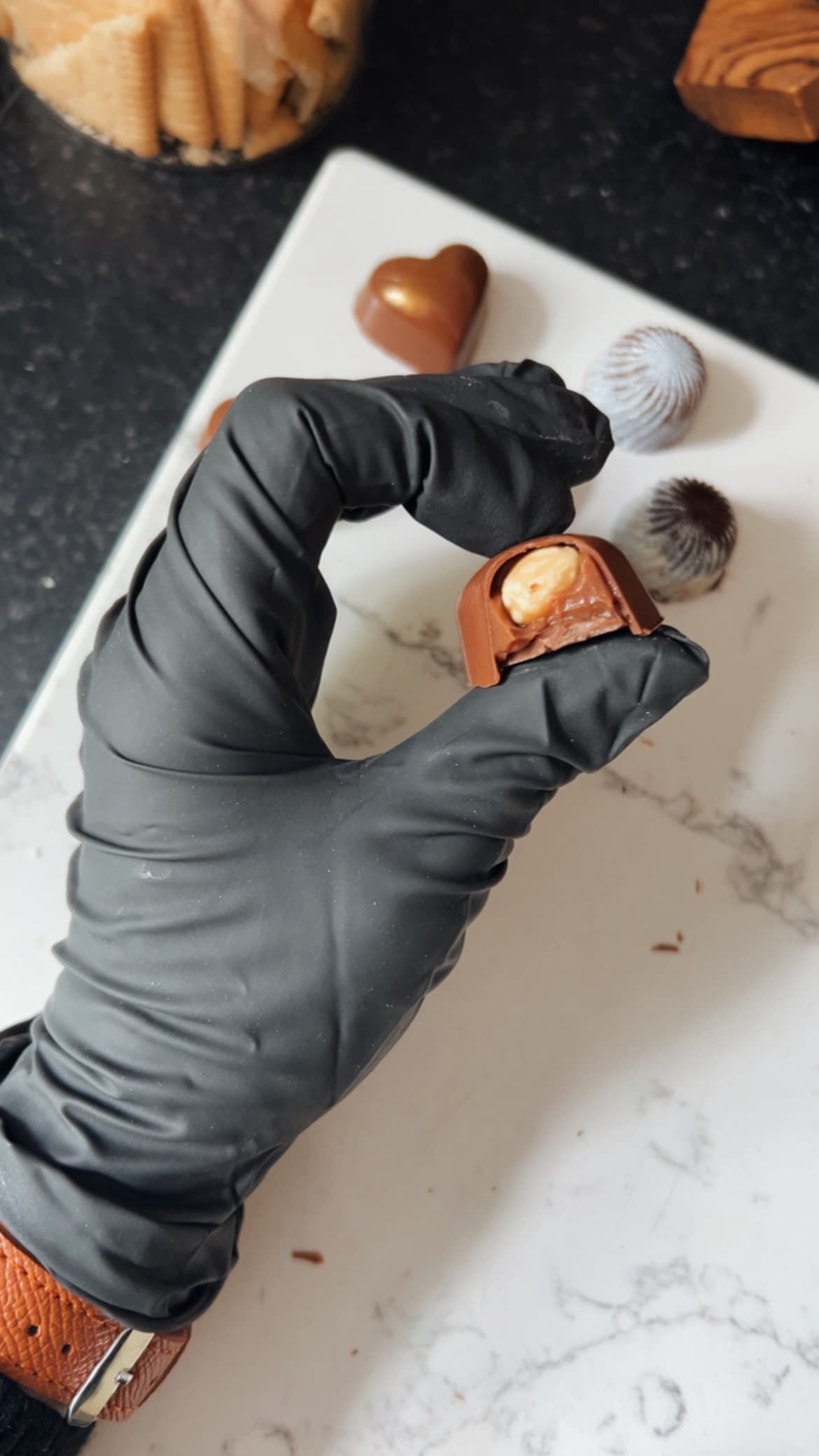 A hazelnut praline cut open to reveal its filling